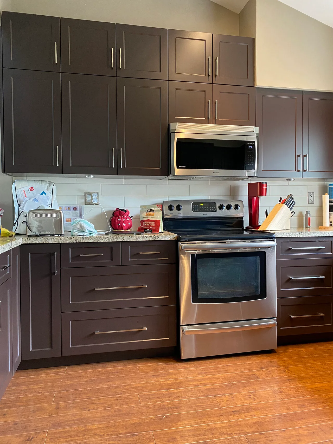 Dark brown doors and drawers with slim metal handles.