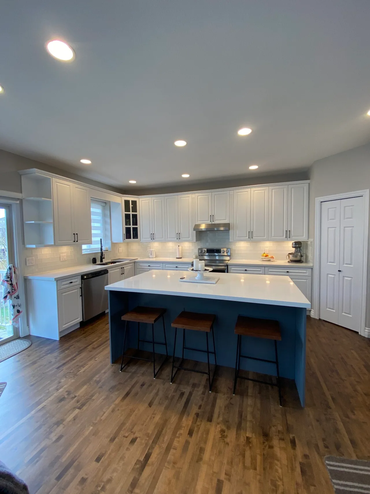 White perimeter cabinets and a contrasting blue island.
