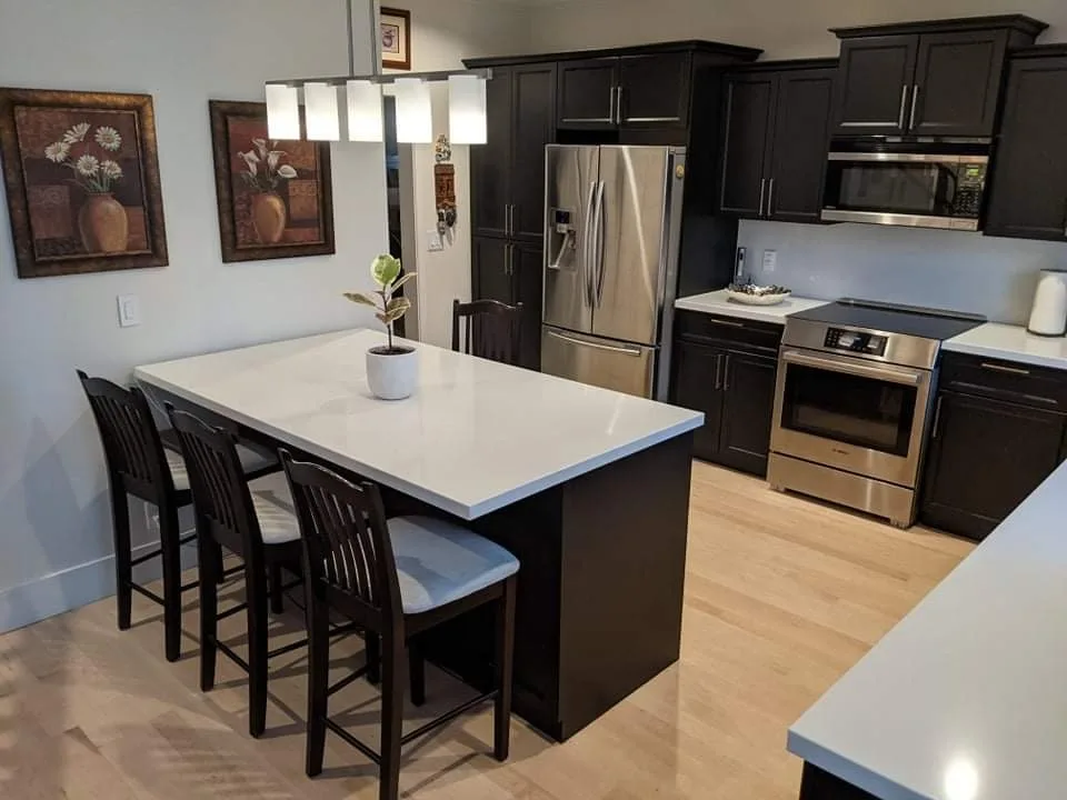 Dark cabinetry paired with pale countertops.